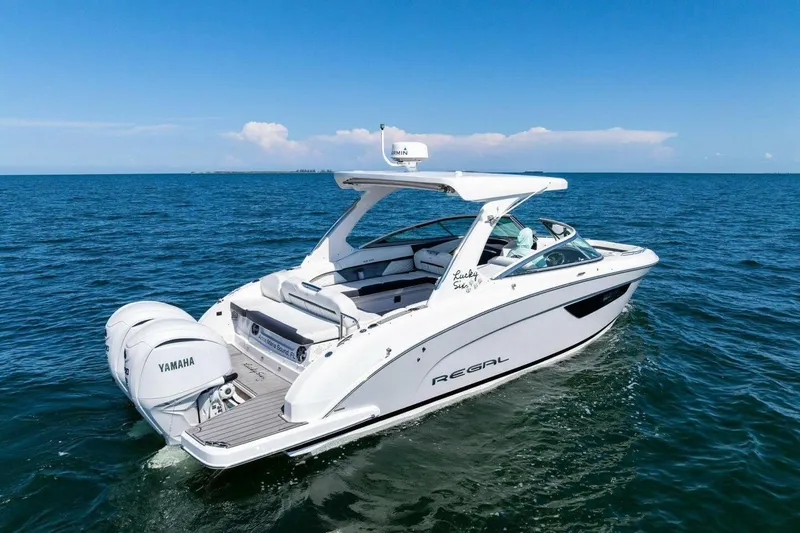  Yacht Photos Pics 2022 Regal 33 OBX boat cruising on open water with Yamaha engines.