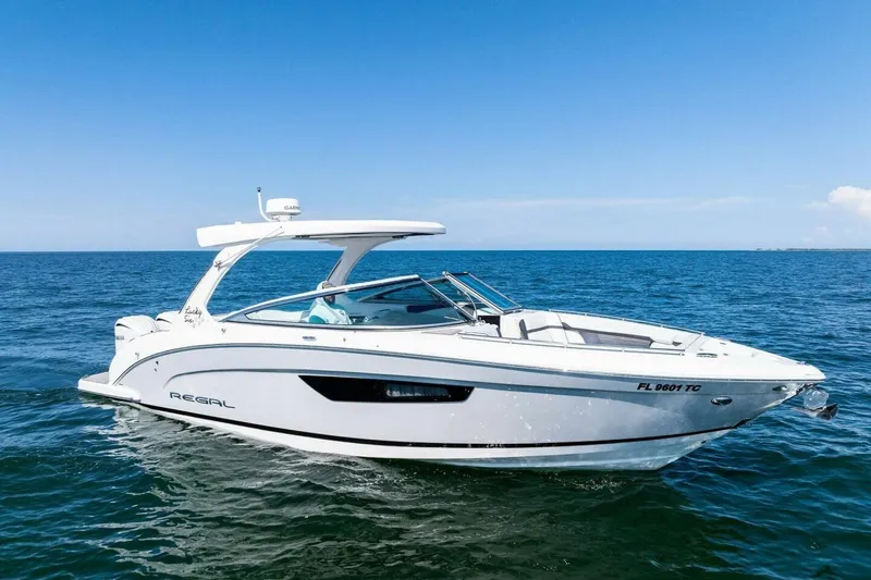  Yacht Photos Pics 2022 Regal 33 OBX boat cruising on open water under clear blue sky.