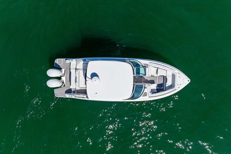  Yacht Photos Pics Aerial view of 2022 Regal 33 OBX boat on green water.