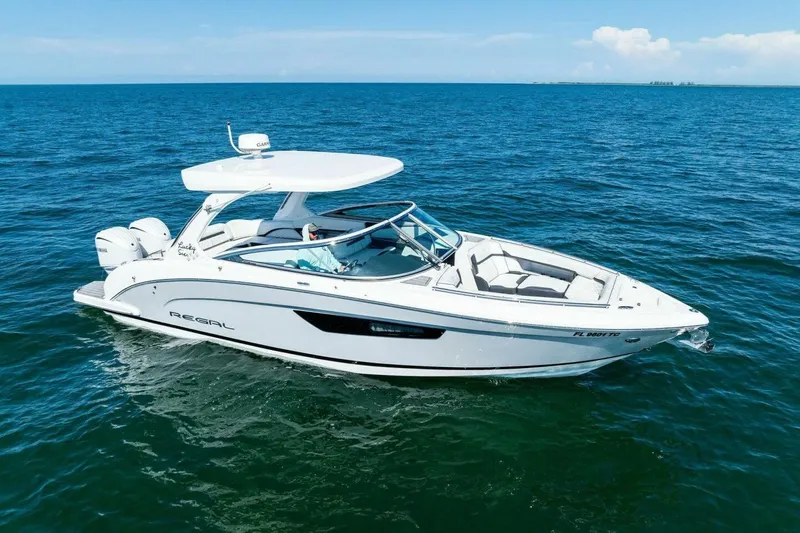  Yacht Photos Pics 2022 Regal 33 OBX boat cruising on open blue water.