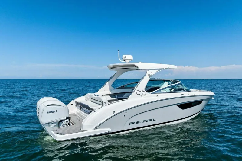  Yacht Photos Pics 2022 Regal 33 OBX boat on open water with Yamaha engine.