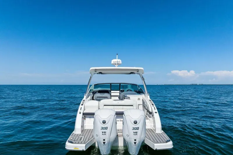  Yacht Photos Pics 2022 Regal 33 OBX boat on open water under clear blue sky.