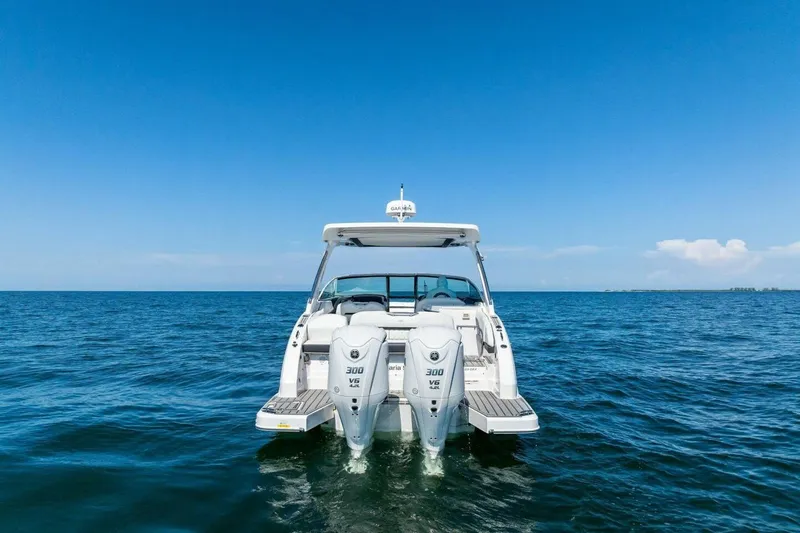  Yacht Photos Pics 2022 Regal 33 OBX boat on open water with twin outboard engines.