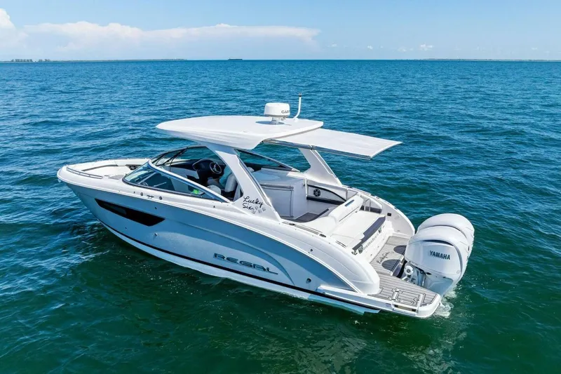  Yacht Photos Pics 2022 Regal 33 OBX boat cruising on open blue water, featuring Yamaha engines.