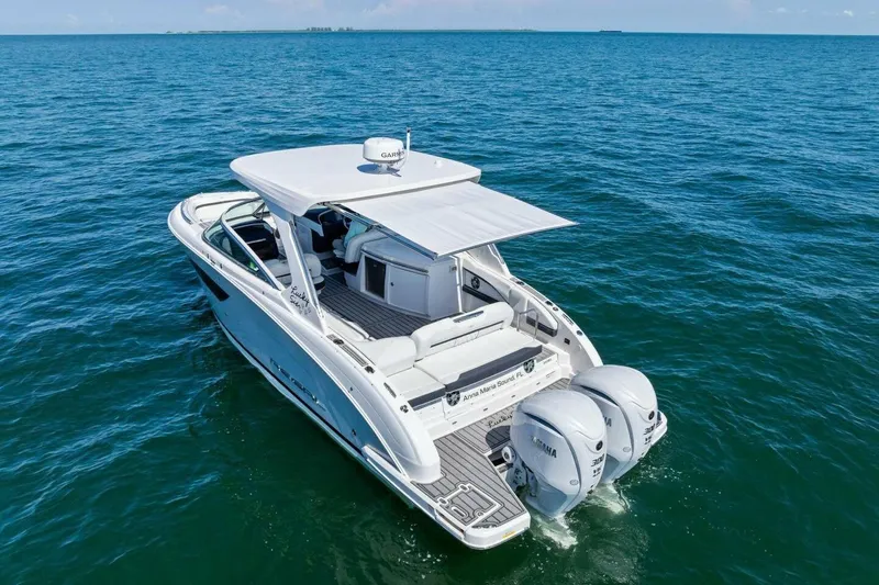  Yacht Photos Pics 2022 Regal 33 OBX boat cruising on open water, featuring twin outboard engines.