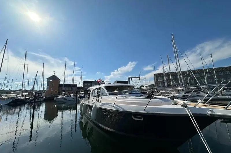Bertie Yacht Photos Pics Luxurious 2024 Nimbus 405 Coupé yacht docked in a sunny marina.