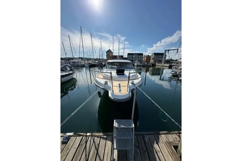Bertie Yacht Photos Pics 2024 Nimbus 405 Coupé yacht docked in a marina under clear blue skies.