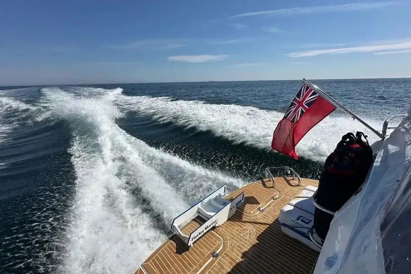 Bertie Yacht Photos Pics Nimbus 405 Coupé 2024 cruising on open sea with flag waving.
