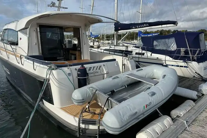 Bertie Yacht Photos Pics 2024 Nimbus 405 Coupé yacht docked with inflatable boat on stern.