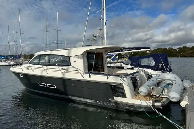 Bertie Yacht Photos Pics 2024 Nimbus 405 Coupé yacht docked at marina under cloudy sky.