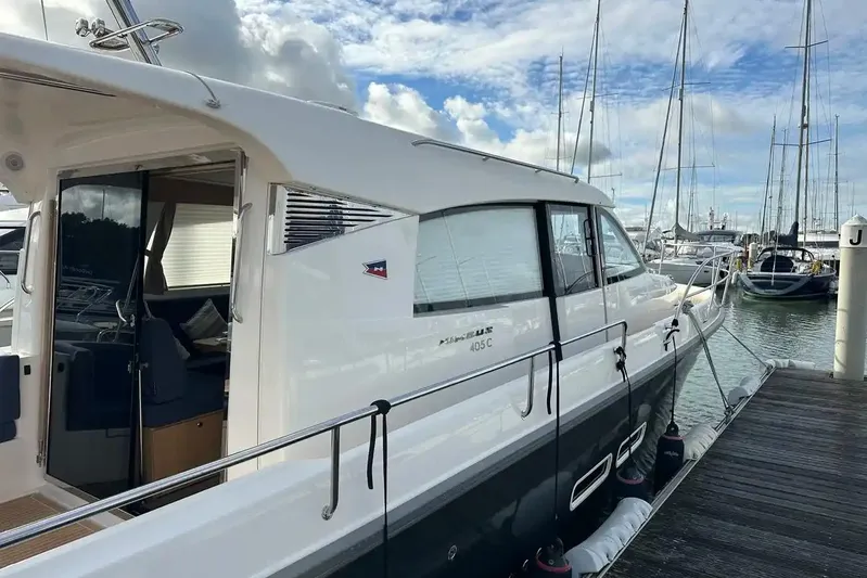 Bertie Yacht Photos Pics 2024 Nimbus 405 Coupé yacht docked at marina under cloudy sky.