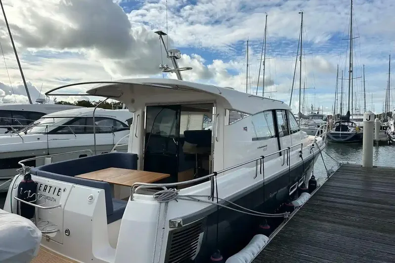 Bertie Yacht Photos Pics 2024 Nimbus 405 Coupé yacht docked at marina under cloudy sky.