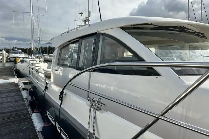 Bertie Yacht Photos Pics 2024 Nimbus 405 Coupé yacht docked at marina under cloudy sky.