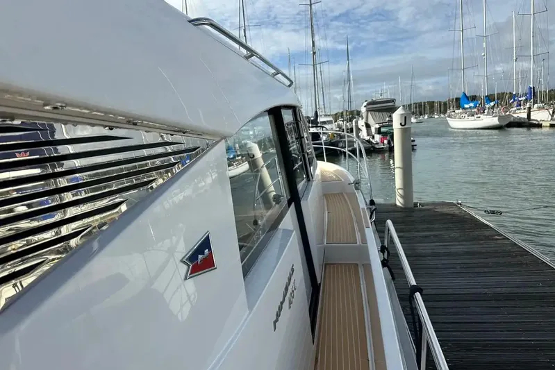 Bertie Yacht Photos Pics 2024 Nimbus 405 Coupé yacht docked at a marina, showcasing sleek design and luxury.