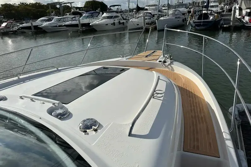 Bertie Yacht Photos Pics 2024 Nimbus 405 Coupé yacht docked at marina, showcasing sleek deck design.