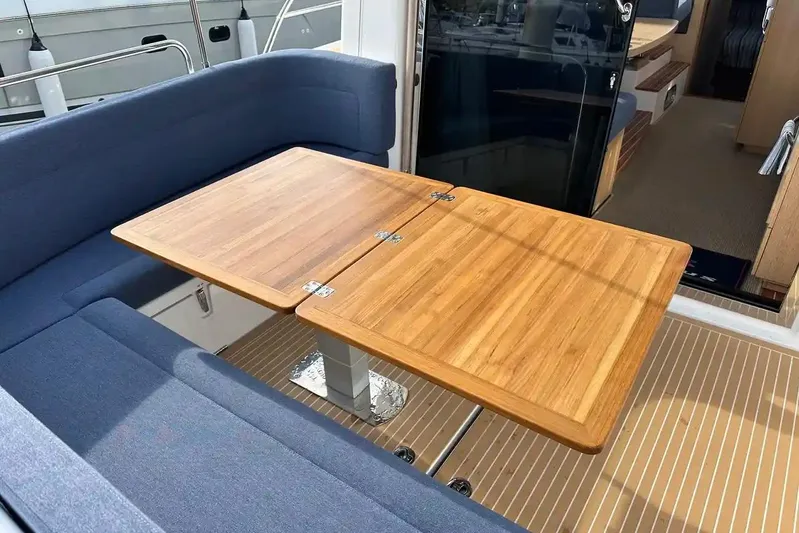 Bertie Yacht Photos Pics 2024 Nimbus 405 Coupé interior with wooden table and blue seating.