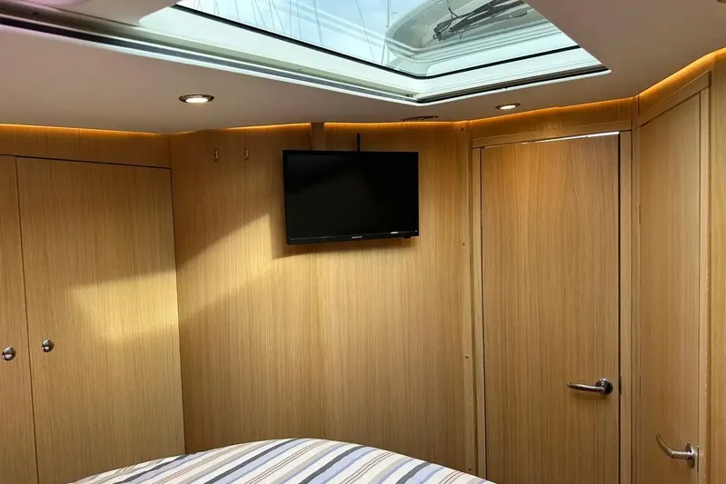 Bertie Yacht Photos Pics Luxurious interior of 2024 Nimbus 405 Coupé with wood paneling and skylight.