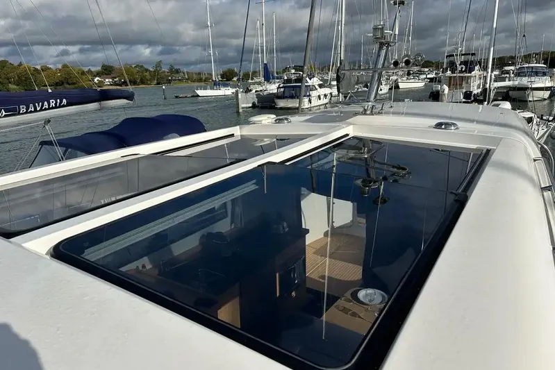 Bertie Yacht Photos Pics 2024 Nimbus 405 Coupé yacht with sleek design, docked in a marina.