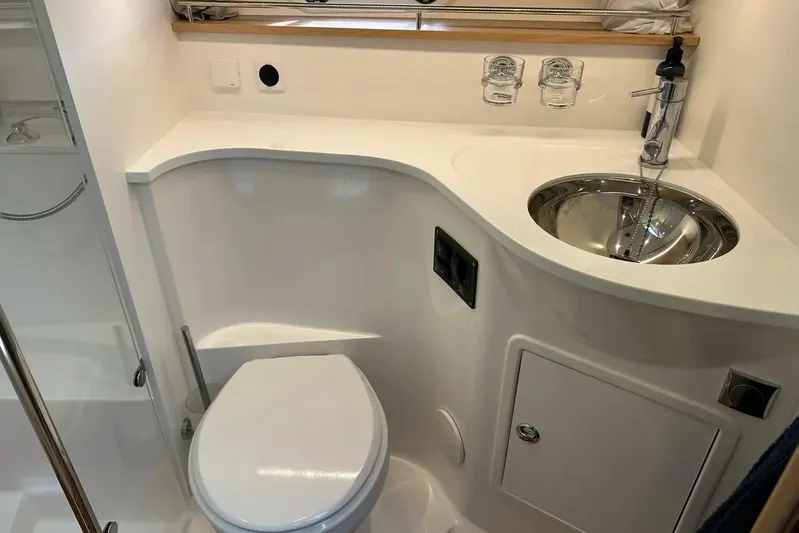Bertie Yacht Photos Pics Compact bathroom in 2024 Nimbus 405 Coupé yacht with modern sink and toilet.