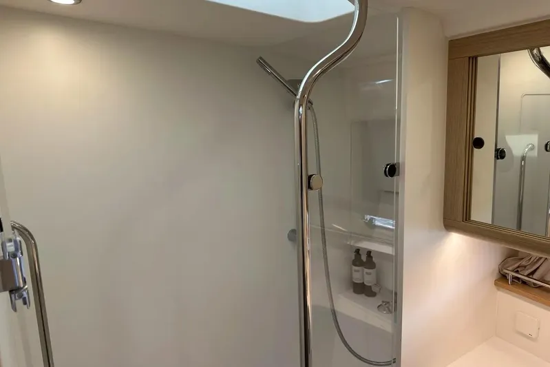 Bertie Yacht Photos Pics Modern bathroom in 2024 Nimbus 405 Coupé yacht with sleek shower and mirrored cabinet.