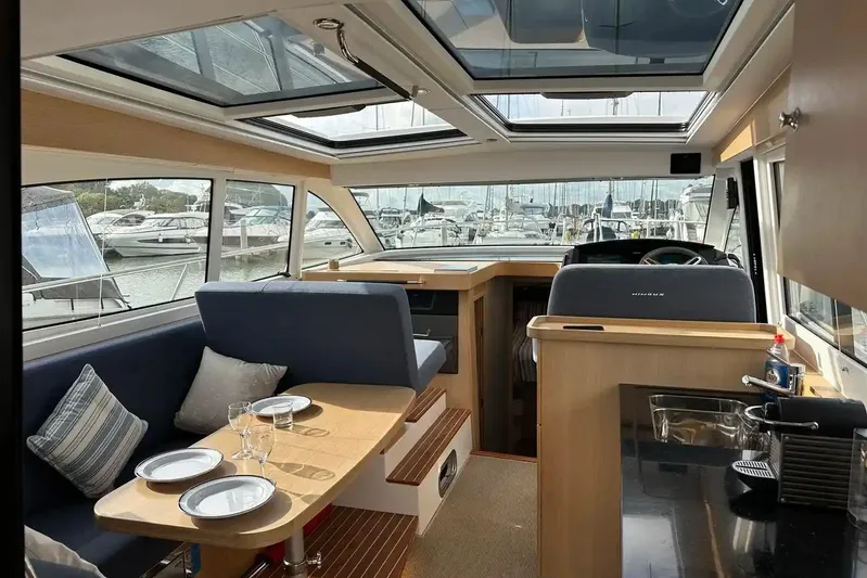 Bertie Yacht Photos Pics Interior of 2024 Nimbus 405 Coupé yacht with modern seating and dining area.