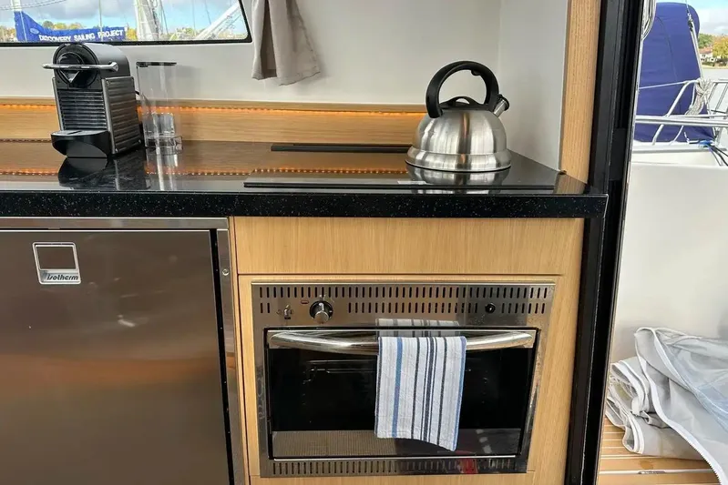 Bertie Yacht Photos Pics Modern kitchen in 2024 Nimbus 405 Coupé yacht with appliances and kettle.