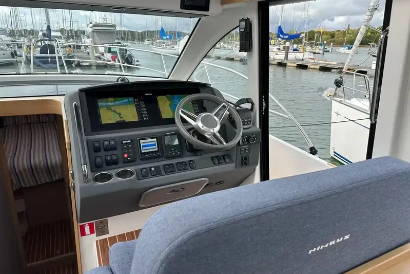 Bertie Yacht Photos Pics Interior view of 2024 Nimbus 405 Coupé helm with navigation screens and steering wheel.
