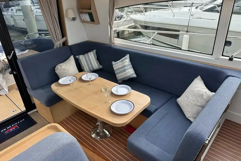 Bertie Yacht Photos Pics Luxurious interior of 2024 Nimbus 405 Coupé with elegant dining area and plush seating.
