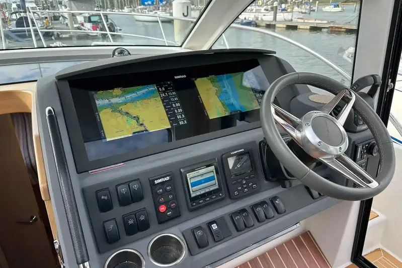 Bertie Yacht Photos Pics 2024 Nimbus 405 Coupé helm with advanced navigation system and steering wheel.