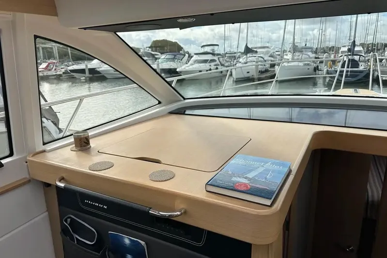 Bertie Yacht Photos Pics Interior view of 2024 Nimbus 405 Coupé yacht with marina backdrop.