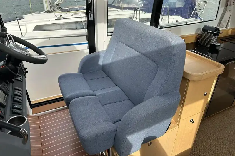 Bertie Yacht Photos Pics Captain's seat in 2024 Nimbus 405 Coupé yacht interior, featuring modern design and controls.