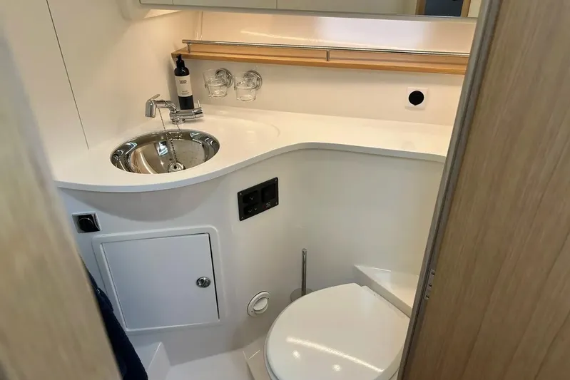 Bertie Yacht Photos Pics 2024 Nimbus 405 Coupé bathroom with modern sink and toilet, compact and stylish design.