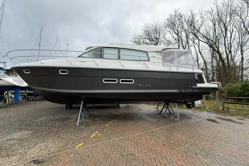 Bertie Yacht Photos Pics 2024 Nimbus 405 Coup&eacute; yacht on stands, displayed outdoors on a cloudy day.
