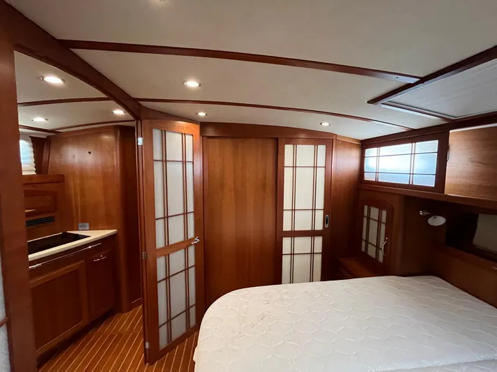 Yacht Photos Pics Luxurious 2013 Sabre 48 Salon Express interior with wood finish and cozy bedroom.
