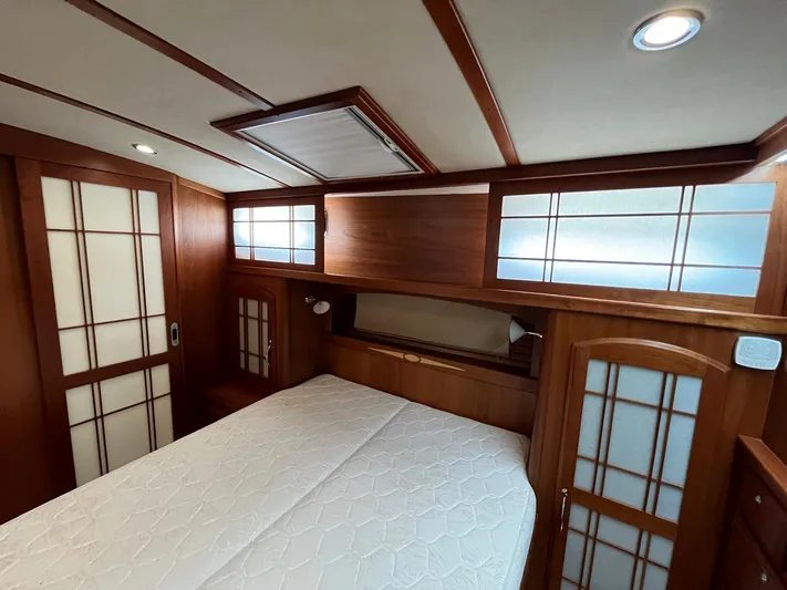  Yacht Photos Pics 2013 Sabre 48 Salon Express bedroom with wood paneling and frosted glass accents.