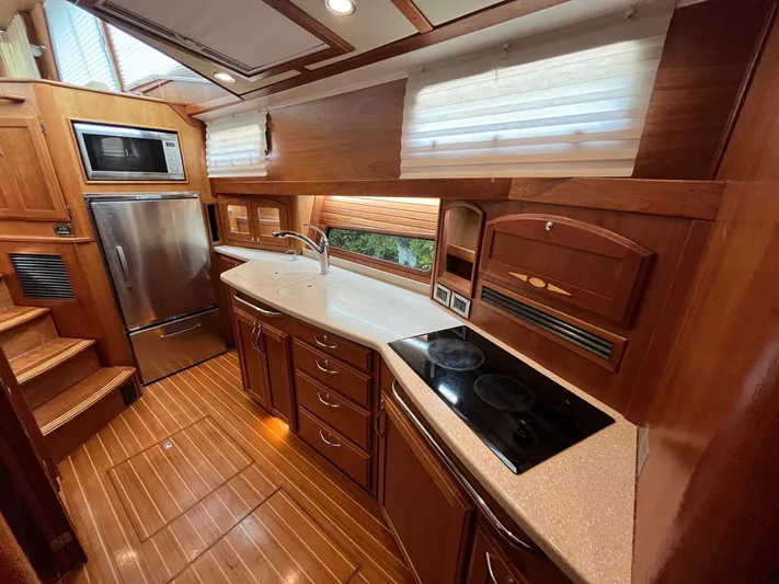  Yacht Photos Pics Luxurious 2013 Sabre 48 Salon Express yacht kitchen with wood cabinetry and modern appliances.