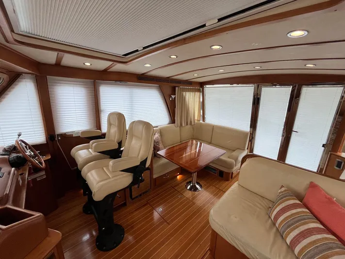  Yacht Photos Pics Interior of 2013 Sabre 48 Salon Express yacht with plush seating and wooden accents.