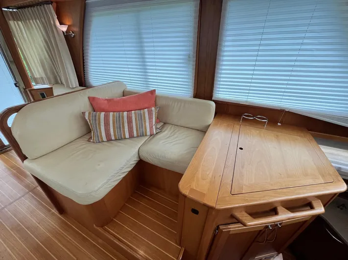  Yacht Photos Pics Interior of 2013 Sabre 48 Salon Express with cozy seating and wooden table.