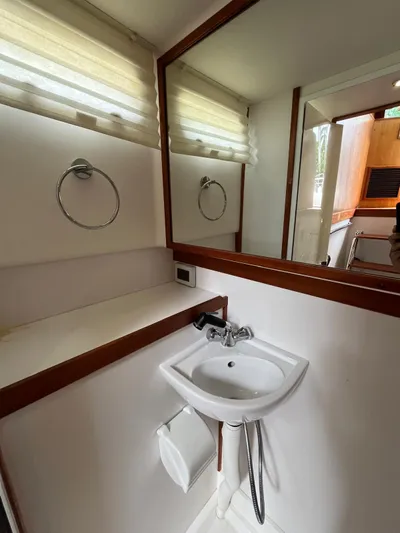  Yacht Photos Pics Compact bathroom in 2013 Sabre 48 Salon Express yacht with sink and mirror.