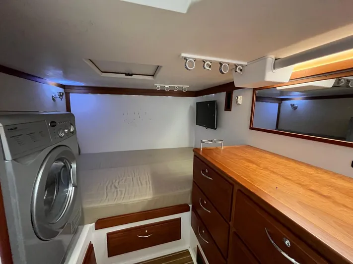  Yacht Photos Pics Interior of 2013 Sabre 48 Salon Express with bed, washer, and wooden cabinetry.