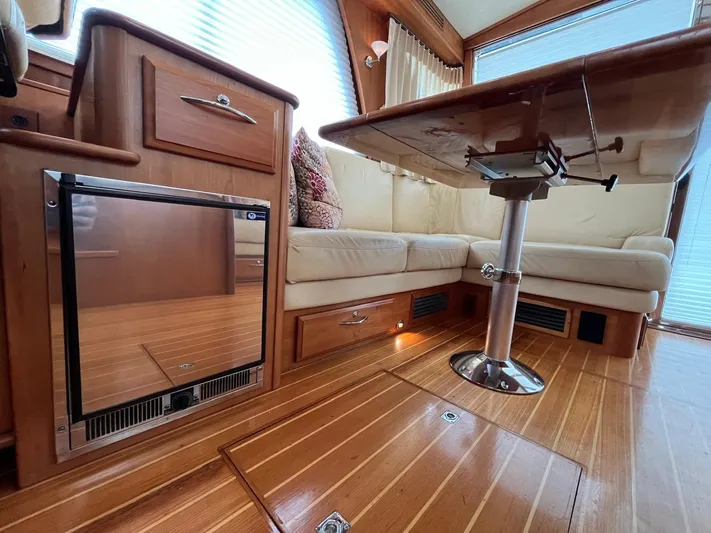  Yacht Photos Pics Interior of 2013 Sabre 48 Salon Express with wood flooring and seating area.