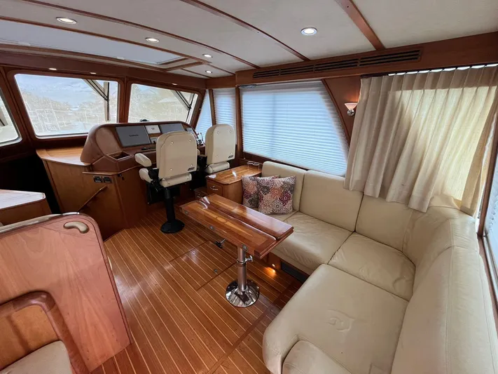  Yacht Photos Pics Interior of 2013 Sabre 48 Salon Express with plush seating and wooden accents.