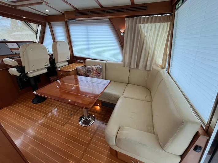  Yacht Photos Pics Interior of 2013 Sabre 48 Salon Express with beige seating and wooden table.