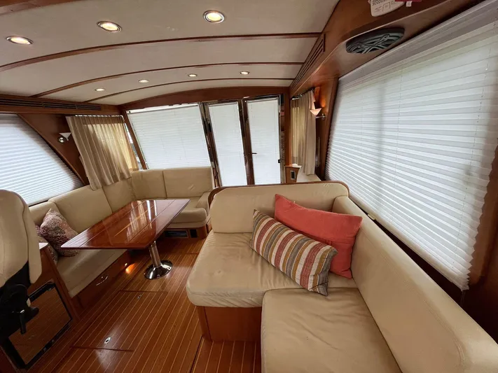  Yacht Photos Pics Interior of 2013 Sabre 48 Salon Express with elegant seating and wooden accents.