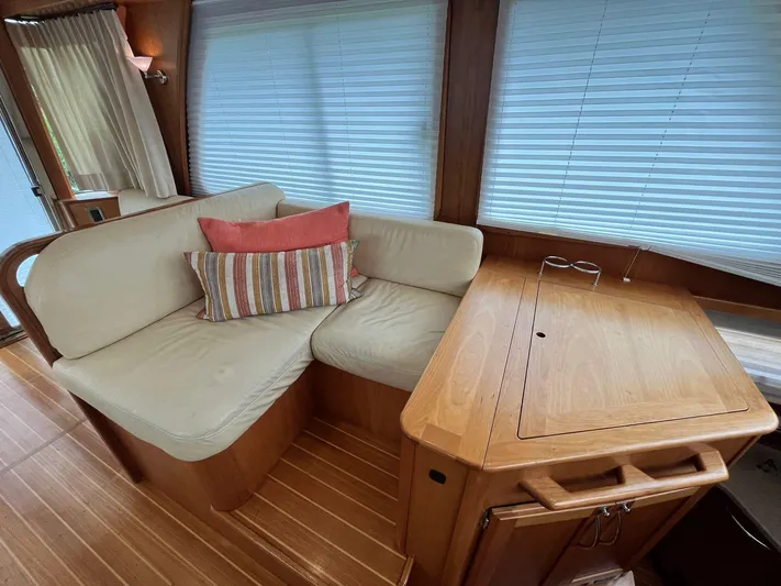  Yacht Photos Pics 2013 Sabre 48 Salon Express interior with cozy seating and wooden table.