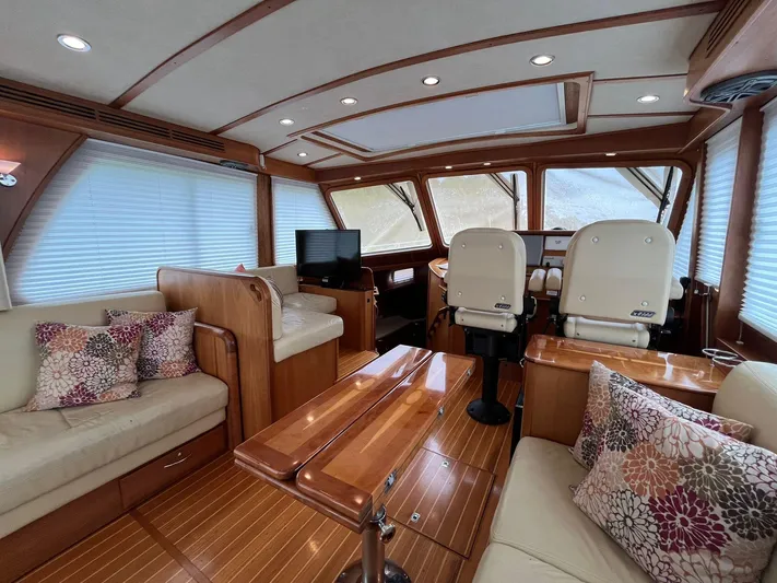  Yacht Photos Pics Luxurious interior of 2013 Sabre 48 Salon Express yacht with plush seating and wood finishes.