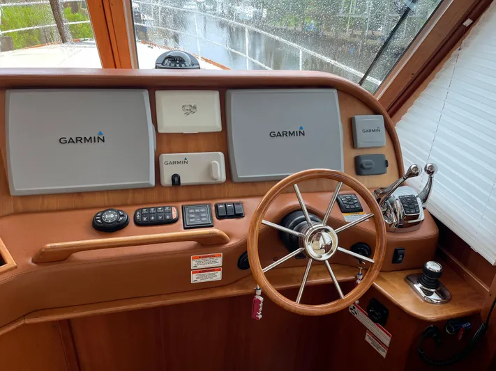  Yacht Photos Pics 2013 Sabre 48 Salon Express helm with Garmin navigation displays and classic wooden steering wheel.