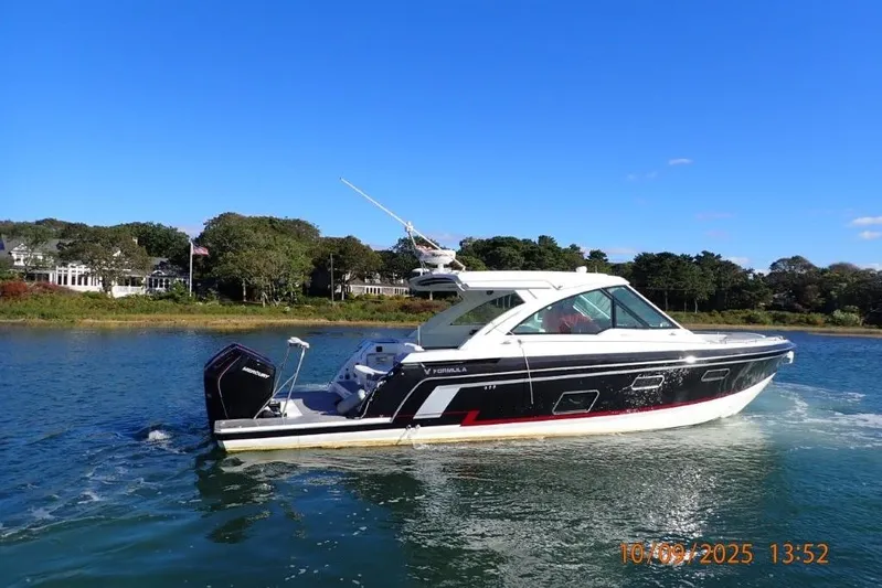  Yacht Photos Pics 2022 Formula 380 Super Sport Crossover OB cruising on a sunny day near shoreline.