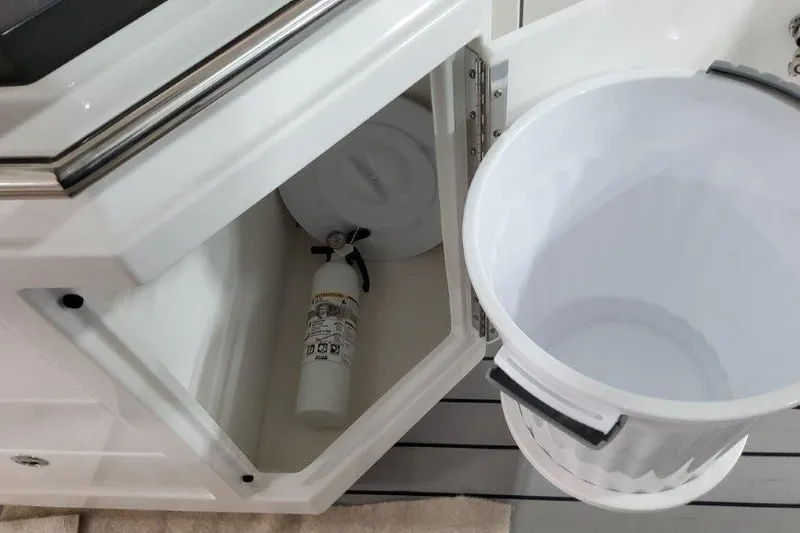  Yacht Photos Pics 2022 Formula 380 Super Sport Crossover OB storage compartment with fire extinguisher and trash bin.