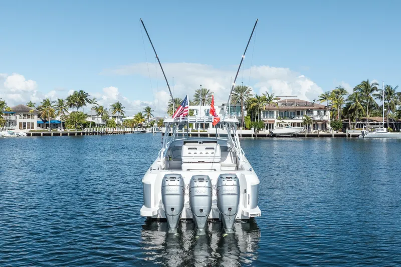 Patti Anne Yacht Photos Pics 2022 Intrepid 409 Valor boat with triple engines on a sunny waterfront.